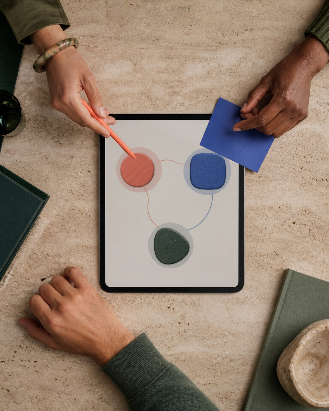Three collaborators connecting a visual workflow on a tablet